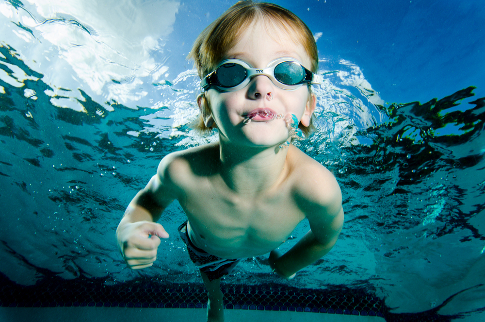 ребенок дышит под водой. дети дуют пузыри в бассейне. ребенок задерживает дыхание в бассейне. два подростка в бассейне. мальчик плавает под водой.